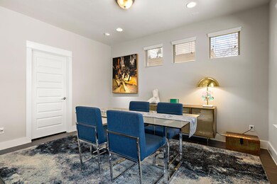 Office with wood finished floors, recessed lighti