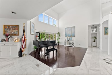 Grand living room with panoramic view to, patio & pool deck