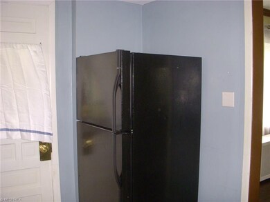 Back door and refrigerator in the kitchen.