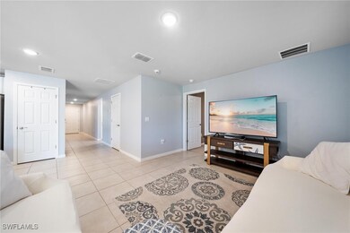 Living room with visible vents, recessed lighting, and light tile patterned floors