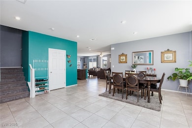 Dining space with light tile patterned floors, sta