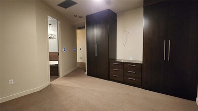 Unfurnished bedroom featuring light carpet and con
