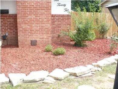 LANDSCAPED FRONT WITH ROCKS AND PLANTS