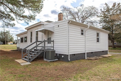 View of side of home featuring crawl space, centra