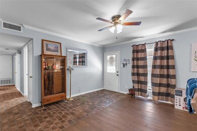 Entryway with ceiling fan, ornamental molding, and