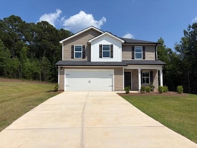 View of front facade with a garage, driveway, and a front yard