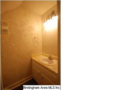 Half bath located under stairs.
