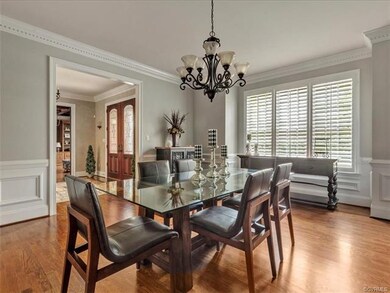 Dining Room with crown moulding, chair rail and bay window. Hardwood floors throughout the first level