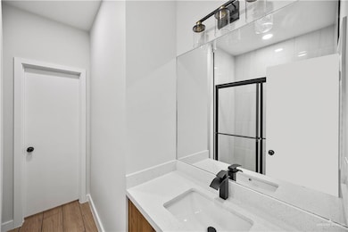 Unfurnished room featuring ceiling fan, baseboards, and wood finished floors