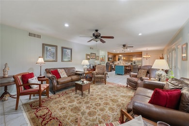 Living area featuring a ceiling fan, recessed ligh