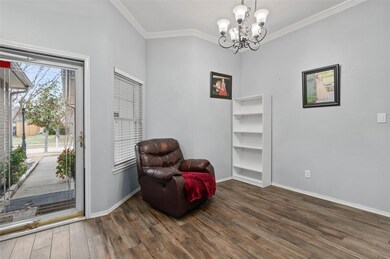 Sitting room featuring chandelier, wood finished f