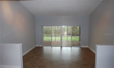 Sunken living room with vaulted ceiling overlookin