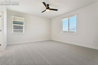 Carpeted spare room with ceiling fan