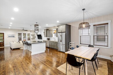 Warm hardwood flooring continues seamlessly throughout, enhancing the flow and continuity of the space.