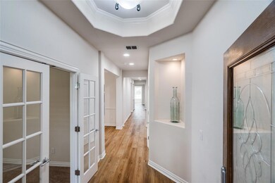 Entry  with a tray ceiling, hardwood / wood-style 