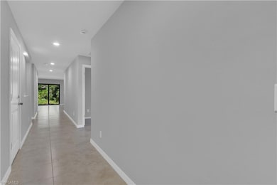 Corridor featuring recessed lighting and baseboard