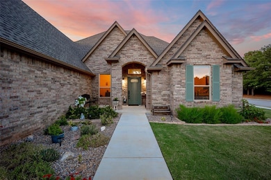 French country style house featuring brick siding,