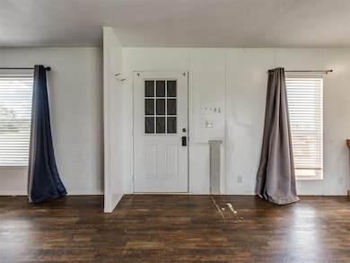Foyer entrance with wood finished floors and healthy amount of natural light