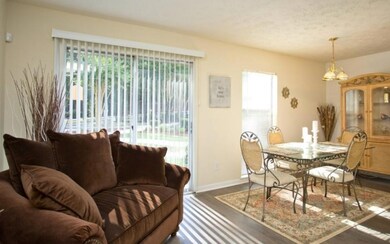 Dining area with a textured ceiling, a notable cha