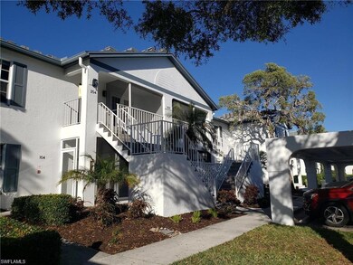 View of front of property featuring stairway, stucco siding, and a porch