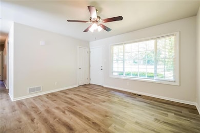 Unfurnished room with baseboards, wood finished fl