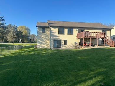 Back of Home Has Deck and Patio