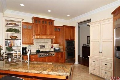 Granite slab counters; cherry cabinetry combined w