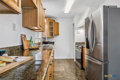 Kitchen with new stove and refrigerator
