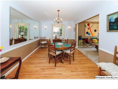 The dining room is large and has refinished hardwo