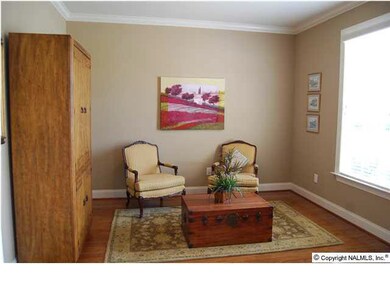 As you walk in to the right is a formal living room, well suited to office or library use.Wood floors