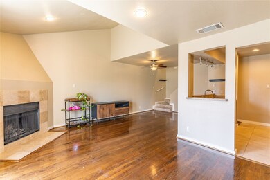 Living room featuring wood finished floors, stairway, a fireplace, recessed lighting, and a ceiling fan