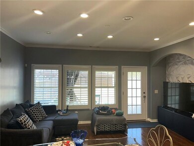 Living area with arched walkways, dark wood-style 