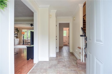 Entrance foyer with baseboards, ornamental molding