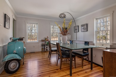 Sunny dining room complete with fireplace.