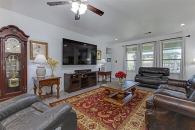 Living room with hardwood / wood-style flooring and ceiling fan