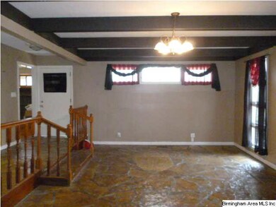View of den with stone flooring