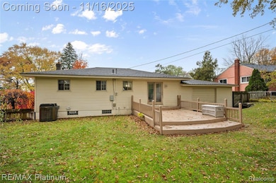 Rear view of house with a wooden deck and a chimney