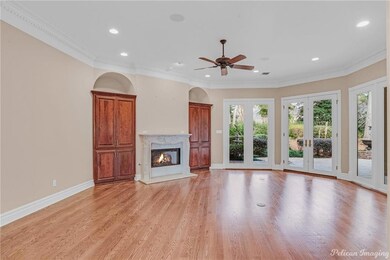 Living room with wood floors, fireplace, built-ins