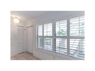 living room overlooking patio with plantation shut