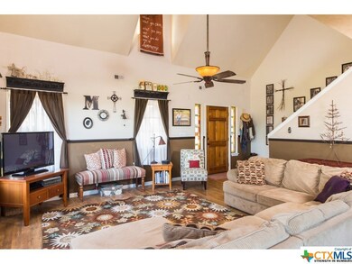 Livingroom feautures high ceilings, ceiling fan, w