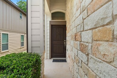 View of exterior entry featuring stone siding and