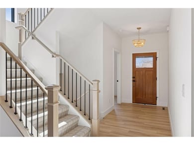 9' main level ceilings! Main level painted or stained newel post with wrought iron spindles! These photos are from a prior built custom home. Majority of shown options are included in the sales price.