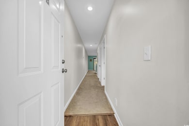 Corridor with baseboards, recessed lighting, wood 