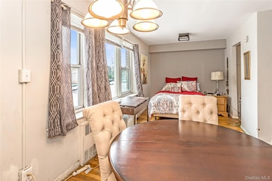 Bedroom with wood finished floors and a chandelier