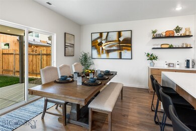 Dining area featuring dark wood-type flooring