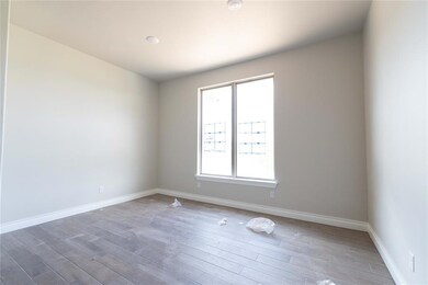 Spare room with wood finished floors and baseboards