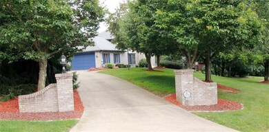 Stately driveway enhanced by lighted brick columns