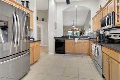 Kitchen featuring light tile patterned floors, amp