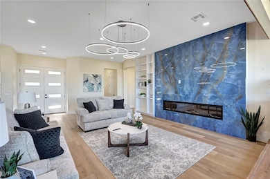 Living room featuring wood finished floors, built