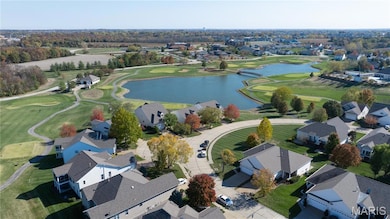 Aerial perspective of suburban area with a large body of water and a golf course
